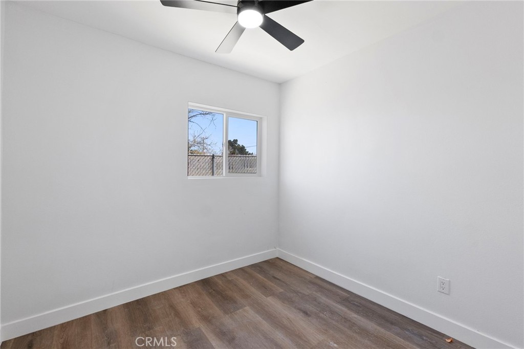 25441 Main Street Barstow, CA 92311 - Photo 27 of 66 an empty room with a window and a fan
