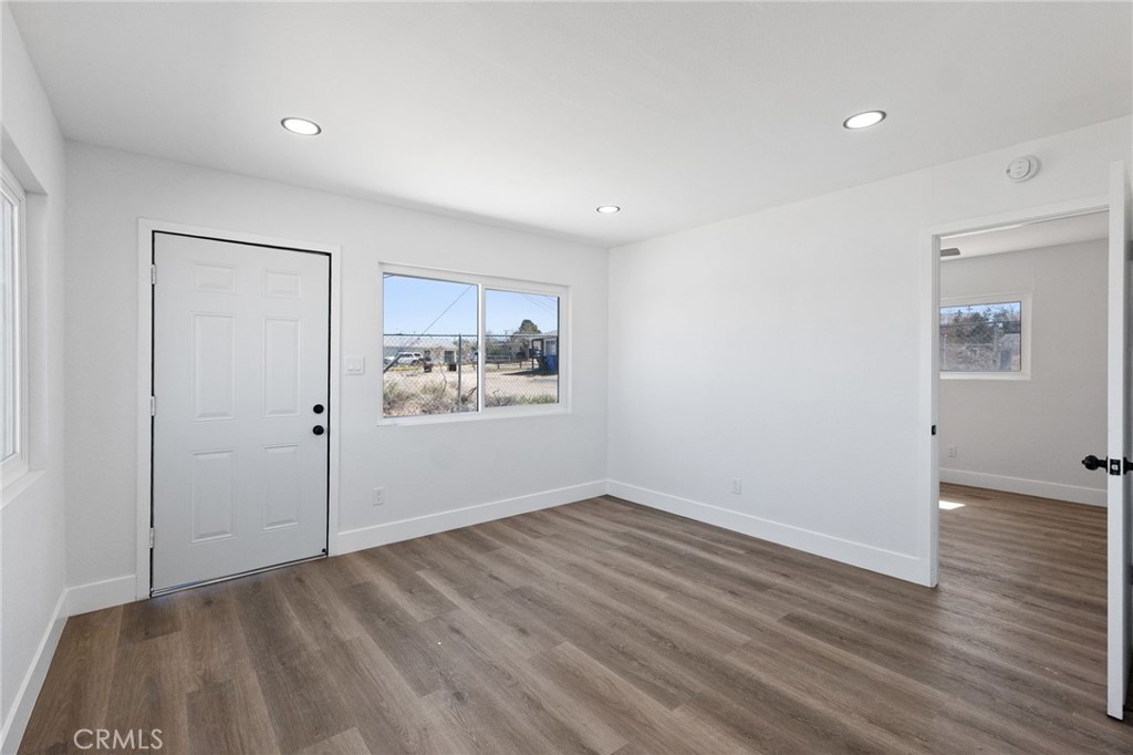 25441 Main Street Barstow, CA 92311 - Photo 40 of 66 wooden floor in an empty room with a window