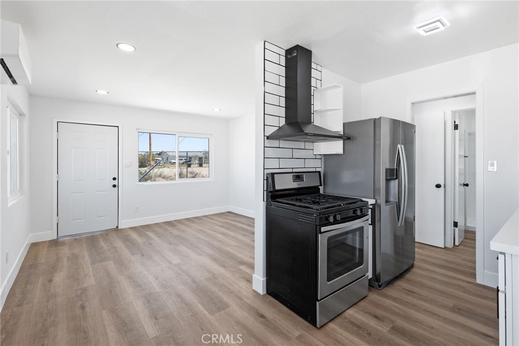 25441 Main Street Barstow, CA 92311 - Photo 42 of 66 a kitchen with a stove and a refrigerator