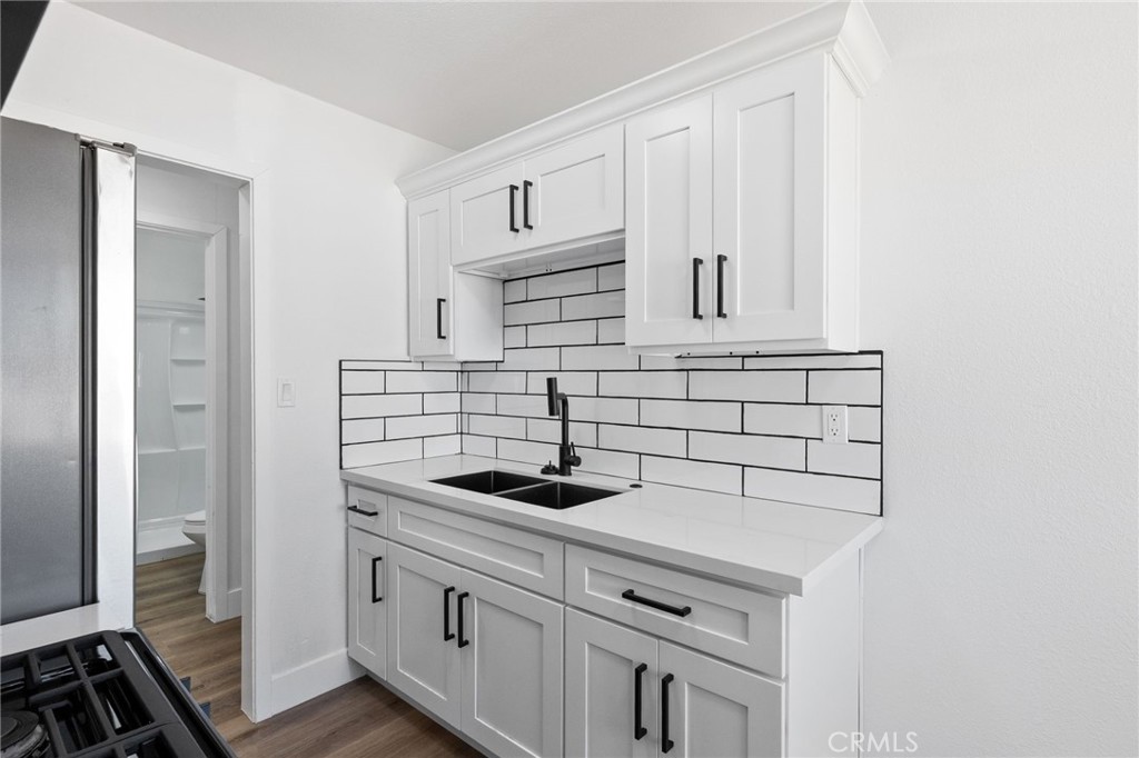 25441 Main Street Barstow, CA 92311 - Photo 45 of 66 a kitchen with white cabinets and appliances