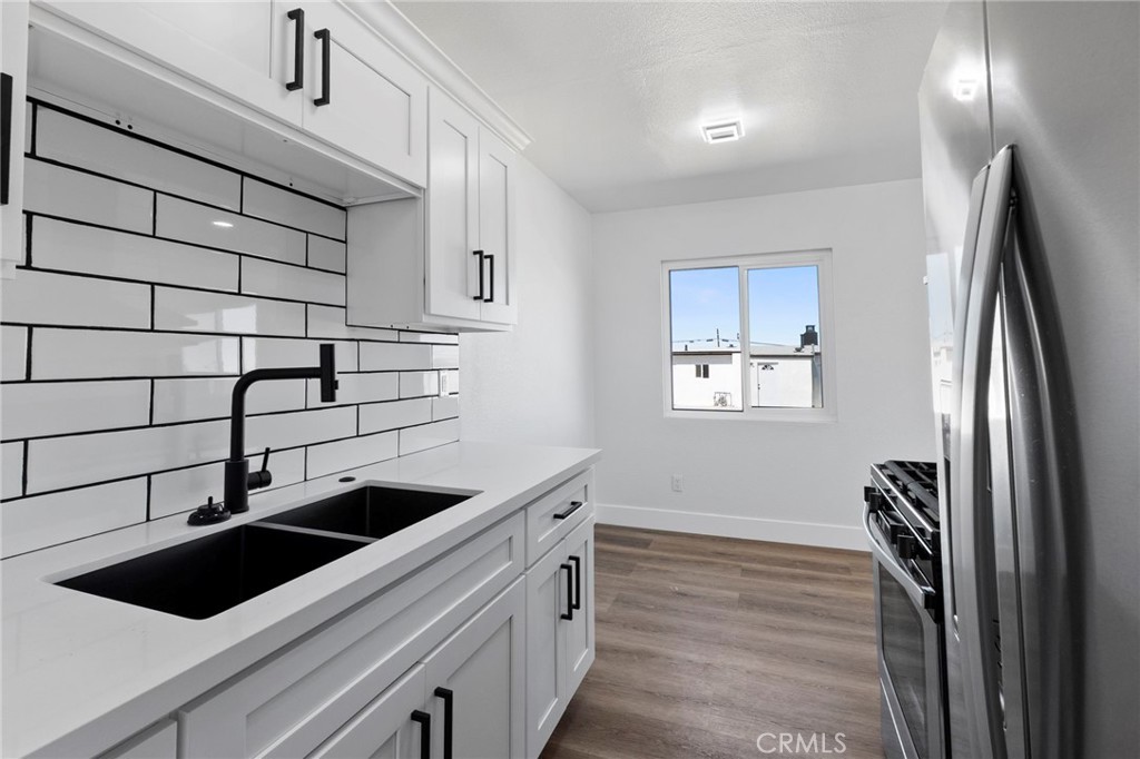 25441 Main Street Barstow, CA 92311 - Photo 47 of 66 a kitchen with a sink and cabinets