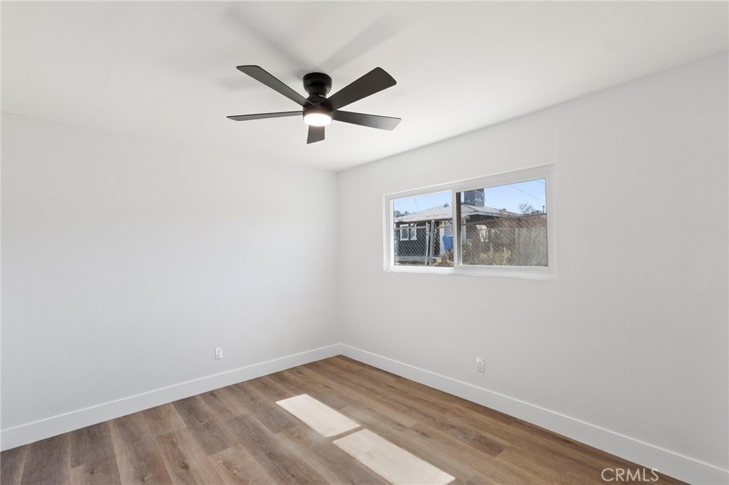 25441 Main Street Barstow, CA 92311 - Photo 48 of 66 an empty room with a window and a fan