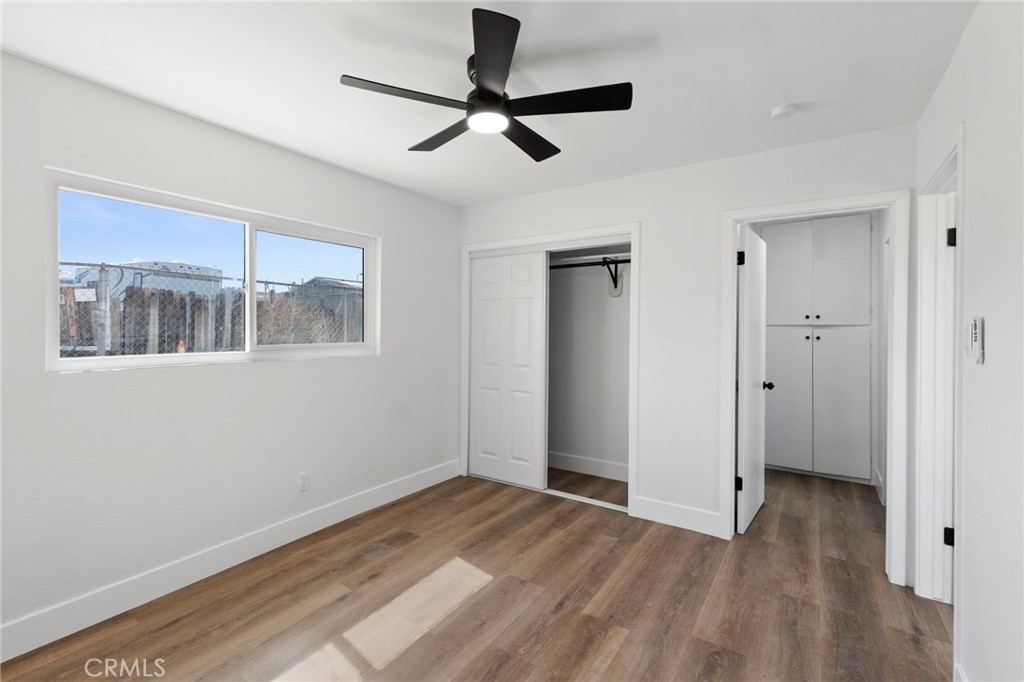 25441 Main Street Barstow, CA 92311 - Photo 50 of 66 a view of empty room with wooden floor and fan