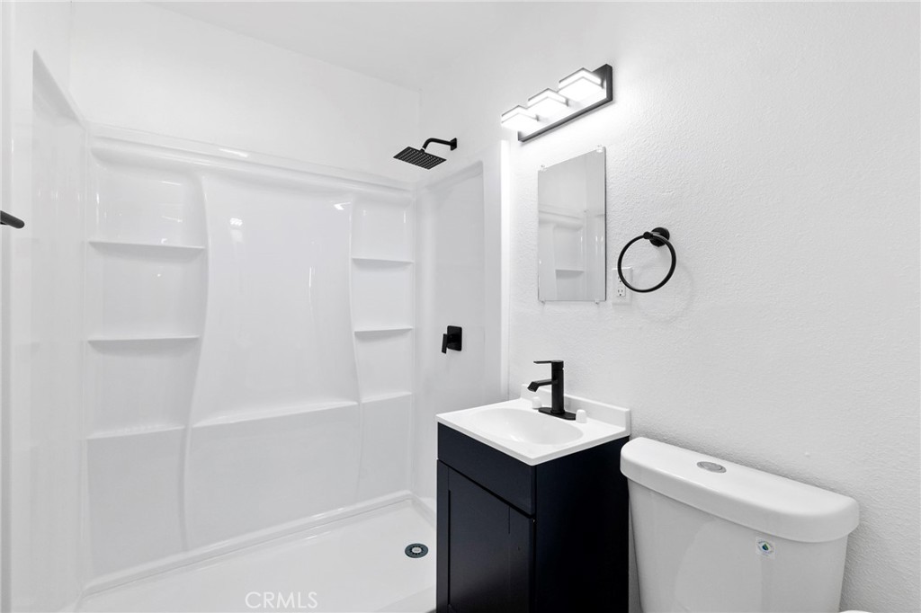 25441 Main Street Barstow, CA 92311 - Photo 52 of 66 a bathroom with a sink a toilet and shower