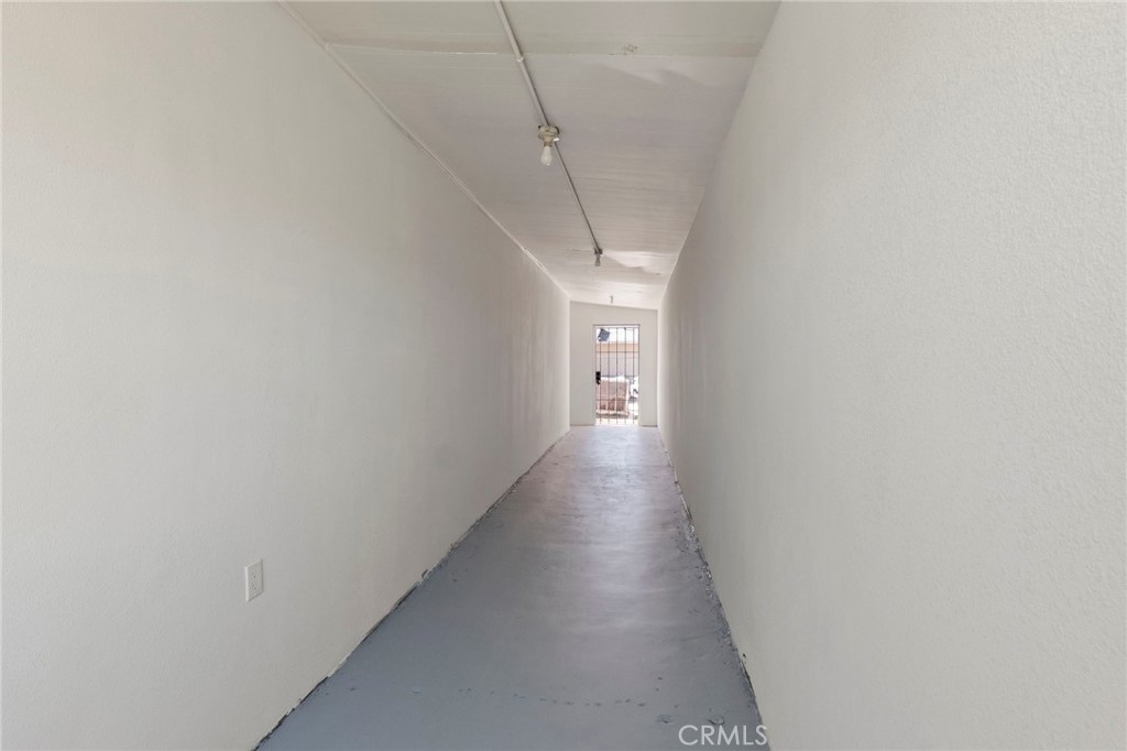 25441 Main Street Barstow, CA 92311 - Photo 8 of 66 a view of a hallway with wooden floor