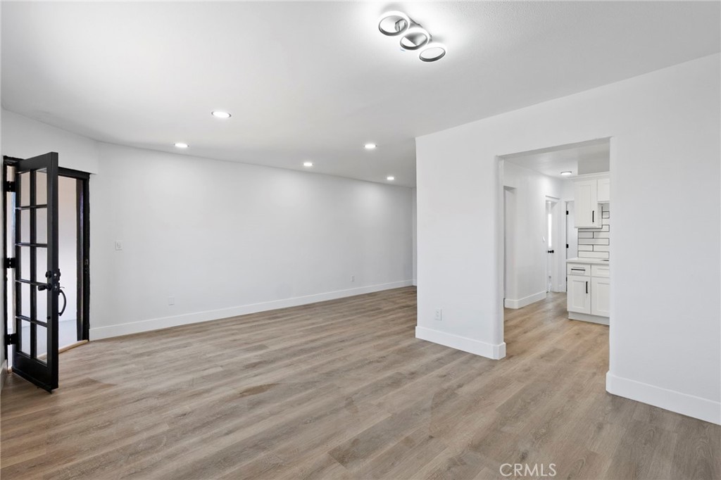 25441 Main Street Barstow, CA 92311 - Photo 10 of 66 wooden floor in an empty room with a window
