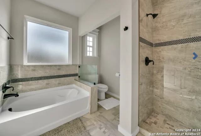 a bathroom with a tub and a shower