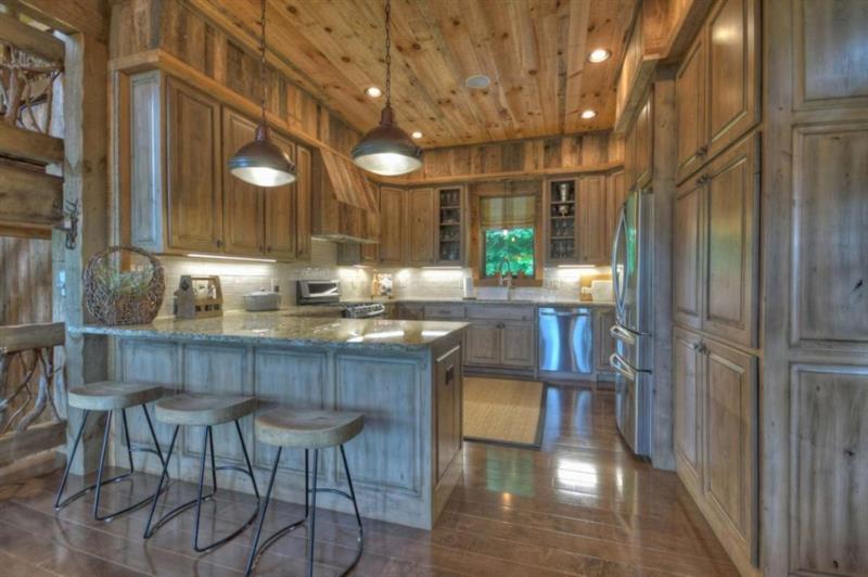 436 Geronimo Road Cherry Log, GA 30522 - Photo 14 of 72 a kitchen with stainless steel appliances granite countertop a table chairs and a chandelier
