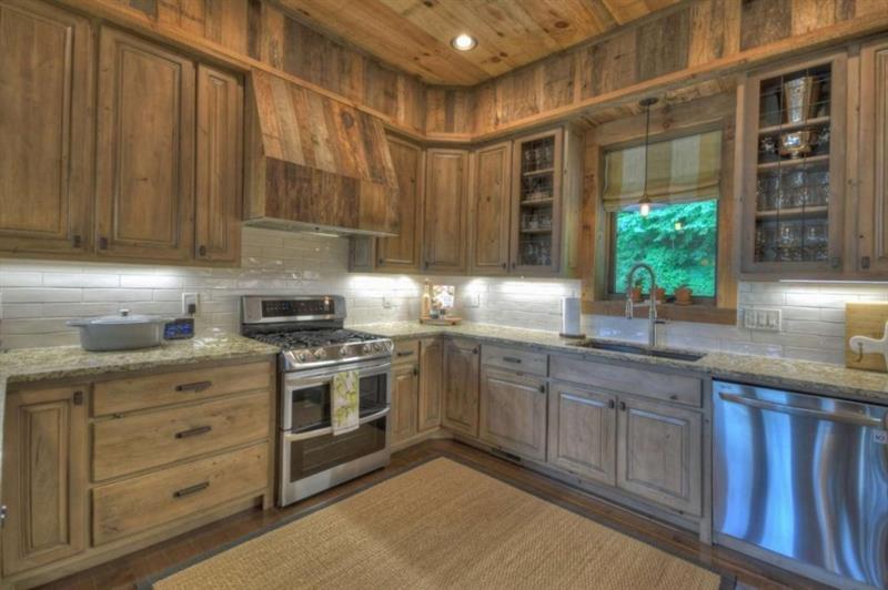 436 Geronimo Road Cherry Log, GA 30522 - Photo 16 of 72 a kitchen with granite countertop stainless steel appliances wooden cabinets a sink and a window