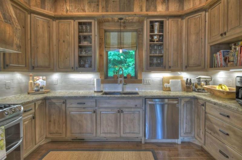 436 Geronimo Road Cherry Log, GA 30522 - Photo 17 of 72 a kitchen with stainless steel appliances granite countertop a sink a stove and a wooden cabinets