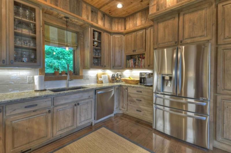 436 Geronimo Road Cherry Log, GA 30522 - Photo 18 of 72 a kitchen with granite countertop stainless steel appliances a refrigerator and a sink