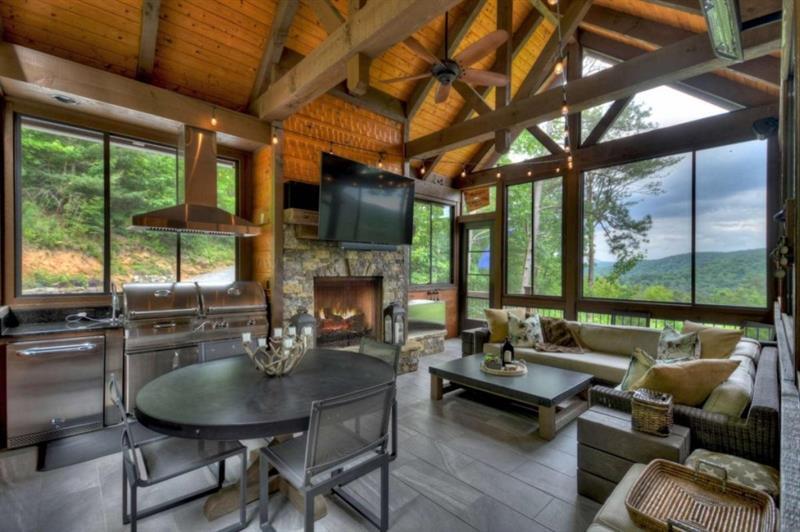 436 Geronimo Road Cherry Log, GA 30522 - Photo 19 of 72 a living room with fireplace furniture a flat screen tv and a large window