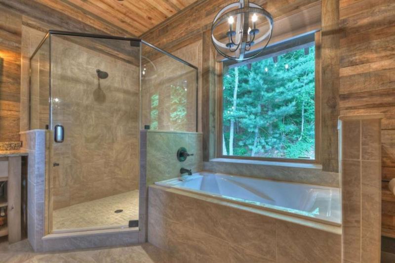 436 Geronimo Road Cherry Log, GA 30522 - Photo 34 of 72 a bathroom with a bathtub and a shower