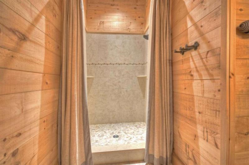 436 Geronimo Road Cherry Log, GA 30522 - Photo 47 of 72 a bathroom with a glass shower door