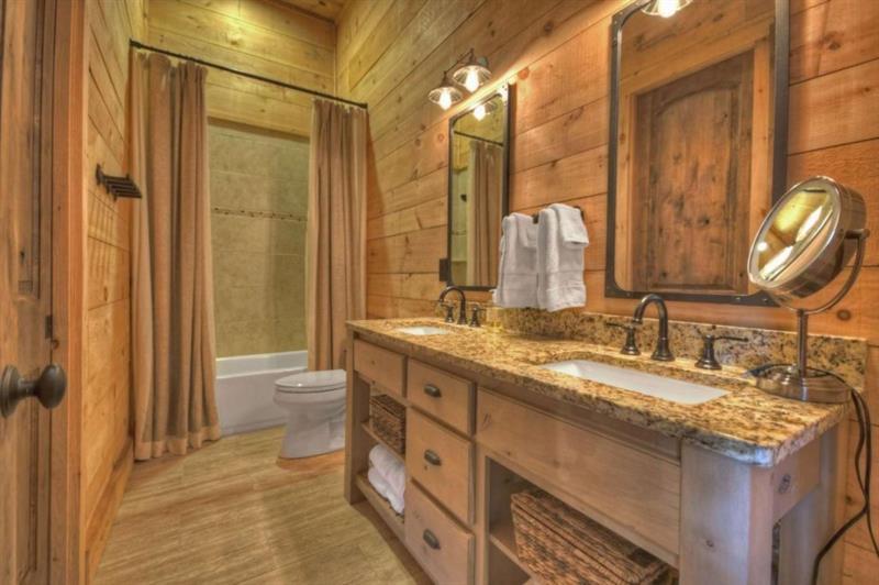 436 Geronimo Road Cherry Log, GA 30522 - Photo 49 of 72 a bathroom with a granite countertop sink and a mirror