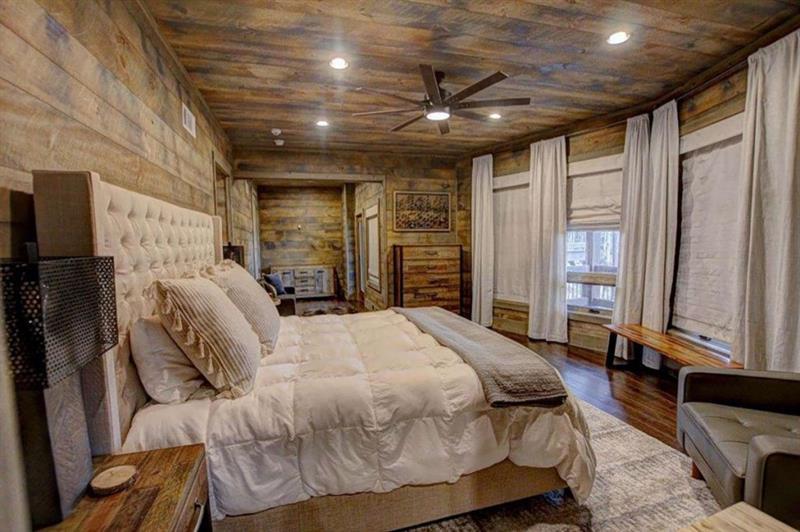 436 Geronimo Road Cherry Log, GA 30522 - Photo 51 of 72 a spacious bedroom with a bed a couch and a large window