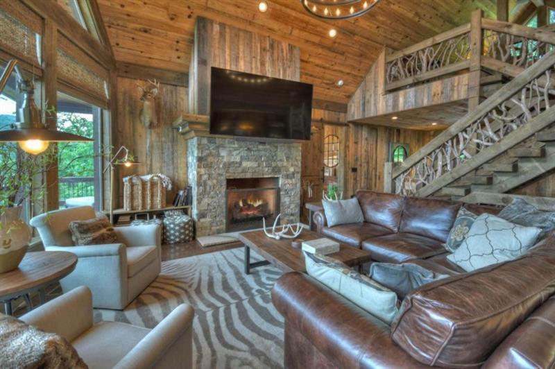 436 Geronimo Road Cherry Log, GA 30522 - Photo 10 of 72 a living room with furniture a flat screen tv and a fireplace