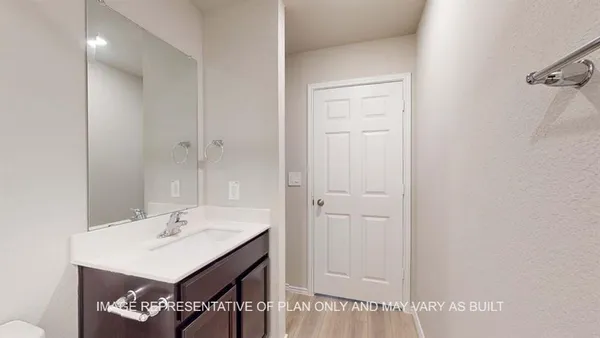 a bathroom with a sink a light fixture and a mirror