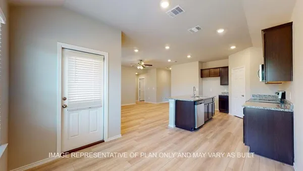 a view of kitchen with stainless steel appliances granite countertop cabinets and wooden floor