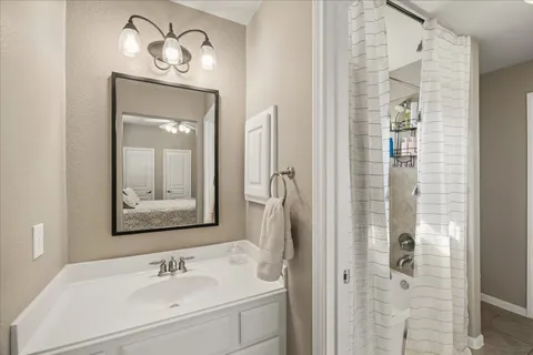 a bathroom with a sink vanity and mirror