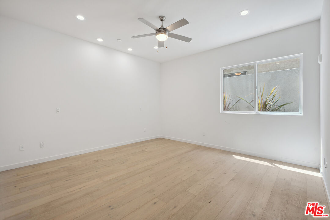 1746 Garfield Place, Unit 102 Los Angeles, CA 90028 - Photo 18 of 32 wooden floor in an empty room with a window