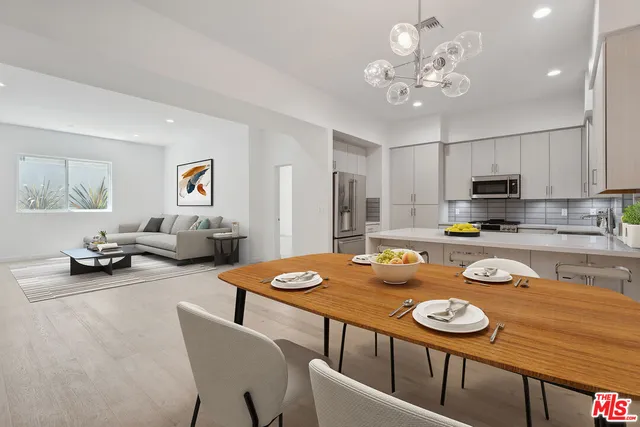 a view of a dining room with furniture and a kitchen