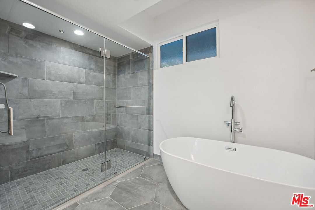 1746 Garfield Place, Unit 102 Los Angeles, CA 90028 - Photo 21 of 32 a bathroom with a bathtub and shower