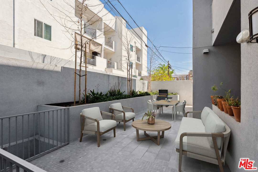 1746 Garfield Place, Unit 102 Los Angeles, CA 90028 - Photo 24 of 32 a terrace with outdoor seating and barbeque oven