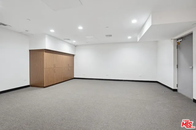a room with furniture gym equipment and a chandelier