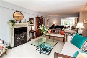 65 Durham Road, Unit 4B Bronxville, NY 10708 - Photo 1 of 1 a living room with furniture a fireplace and a large window