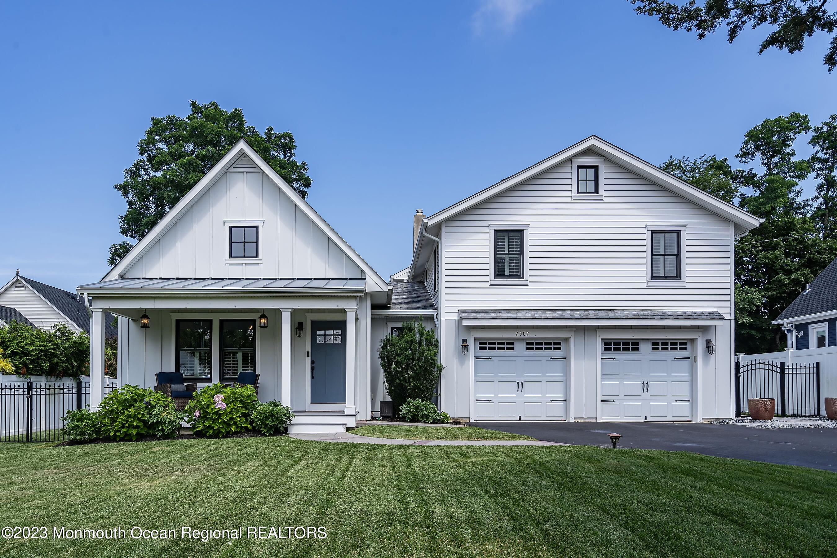 a front view of a house with a yard and porch