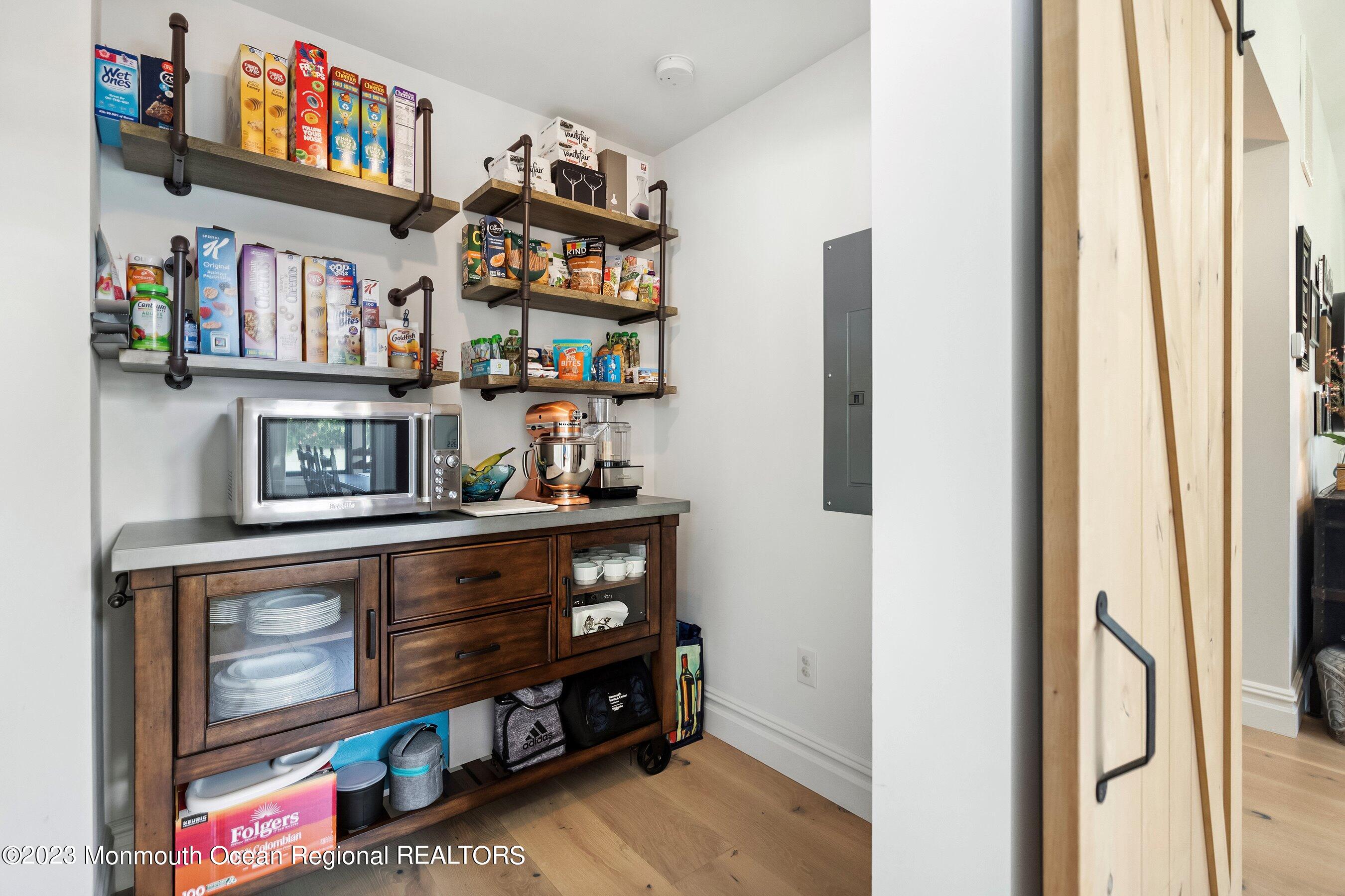 2502 Kipling Avenue Spring Lake, NJ 07762 - Photo 16 of 43 a living room with stainless steel appliances cabinets and a book shelf