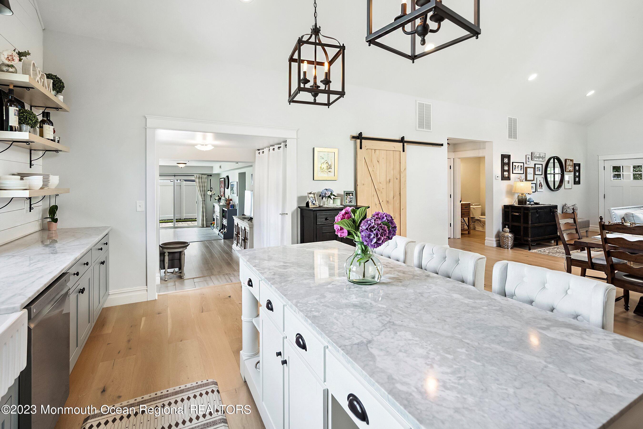 2502 Kipling Avenue Spring Lake, NJ 07762 - Photo 20 of 43 a kitchen with granite countertop a sink a stove top oven a dining table and chairs
