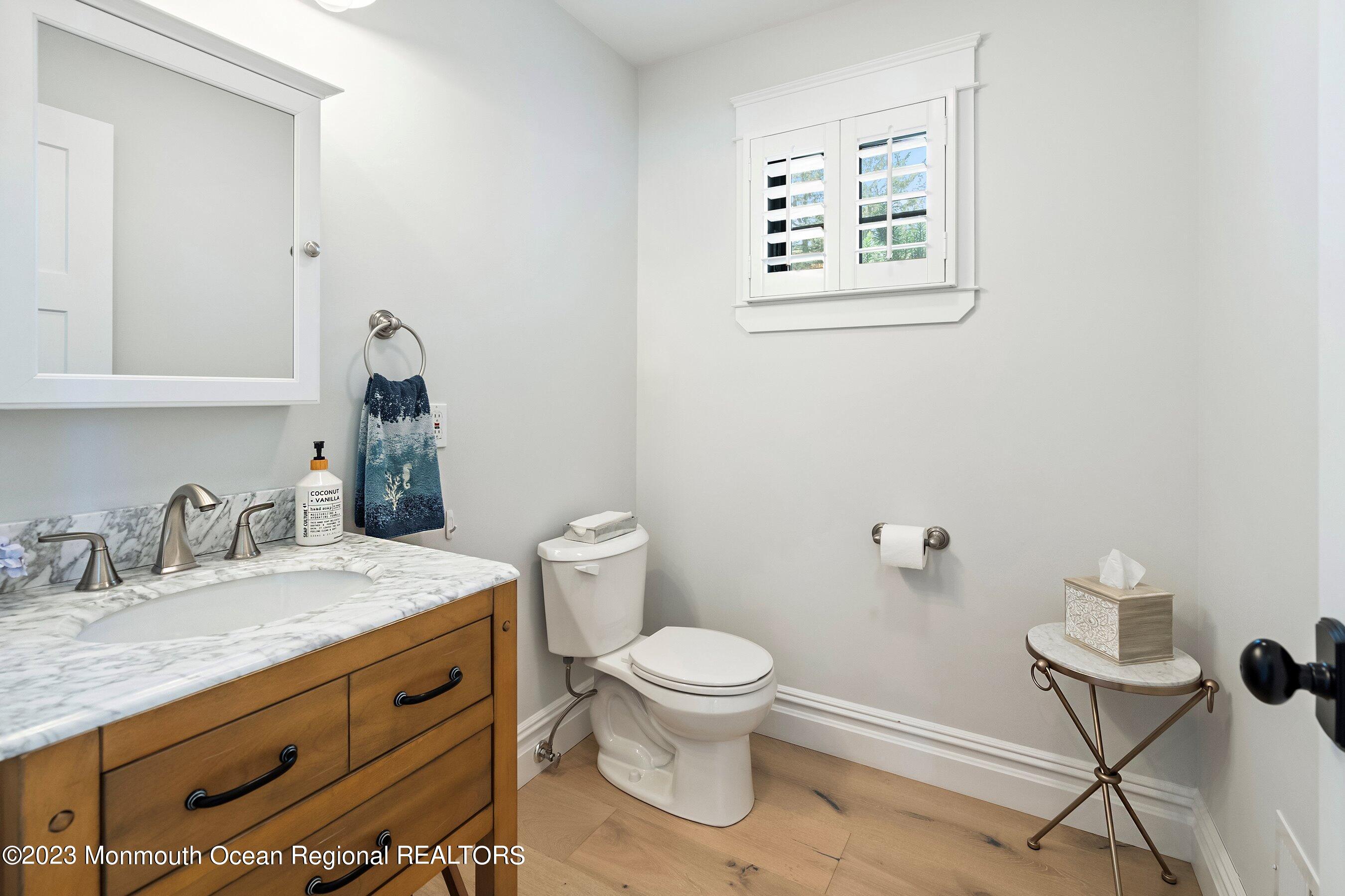 2502 Kipling Avenue Spring Lake, NJ 07762 - Photo 25 of 43 a bathroom with a granite countertop toilet sink and mirror