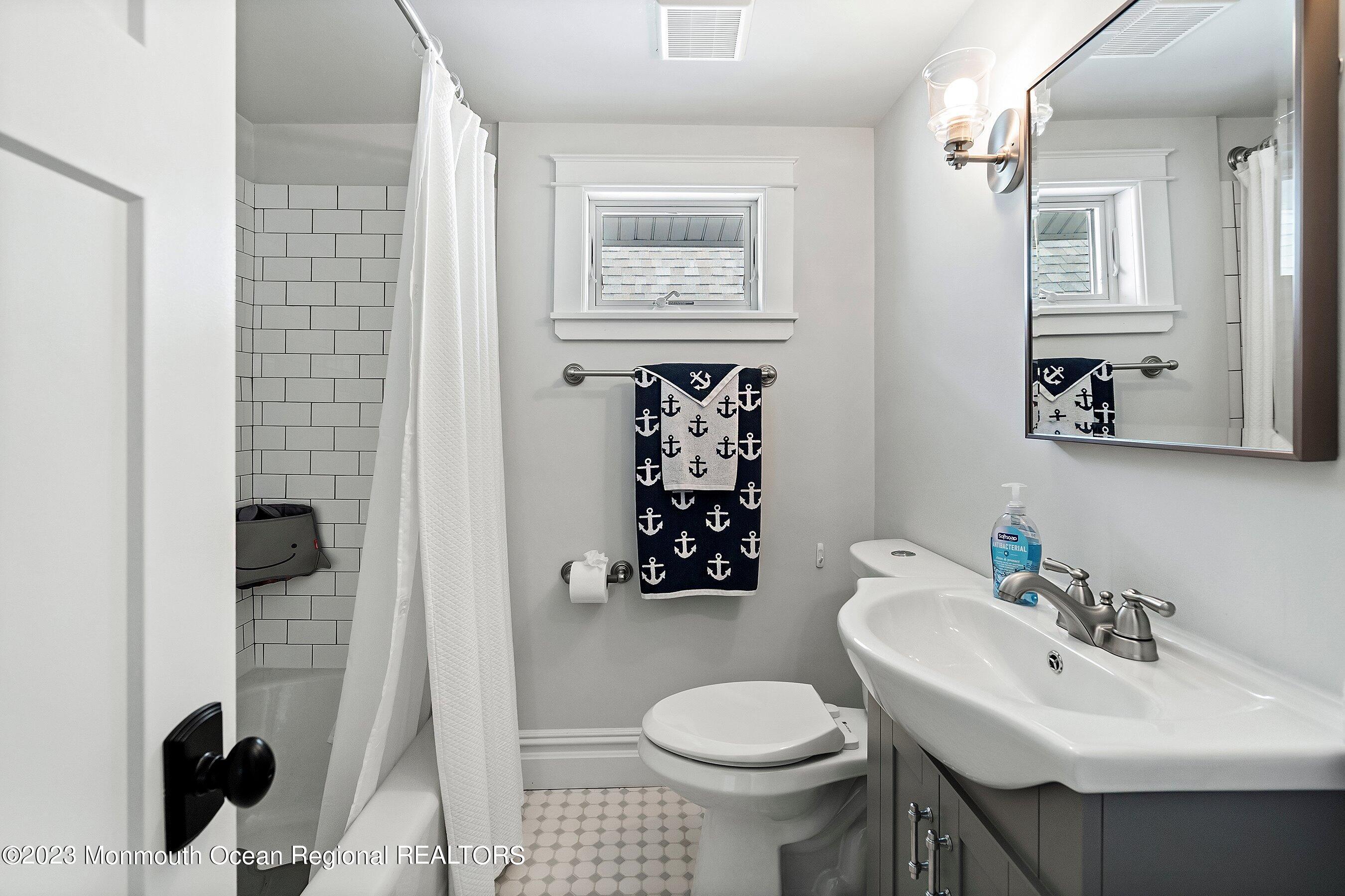 2502 Kipling Avenue Spring Lake, NJ 07762 - Photo 30 of 43 a bathroom with a sink toilet and mirror