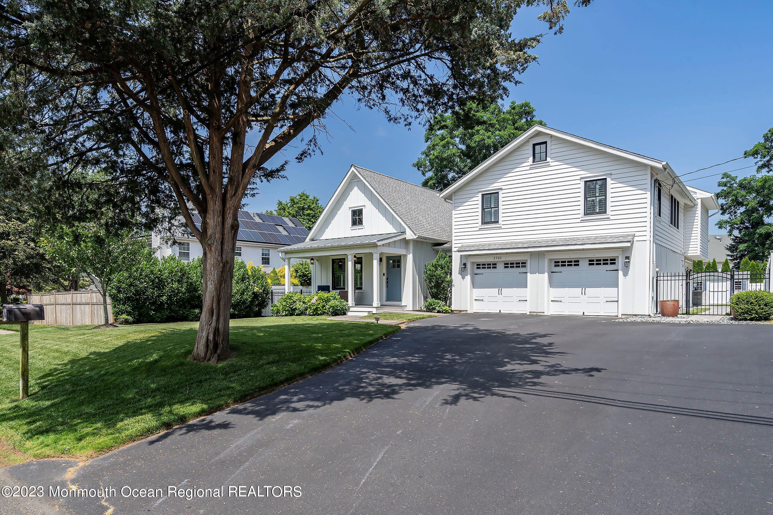 2502 Kipling Avenue Spring Lake, NJ 07762 - Photo 5 of 43 a front view of a house with a garden