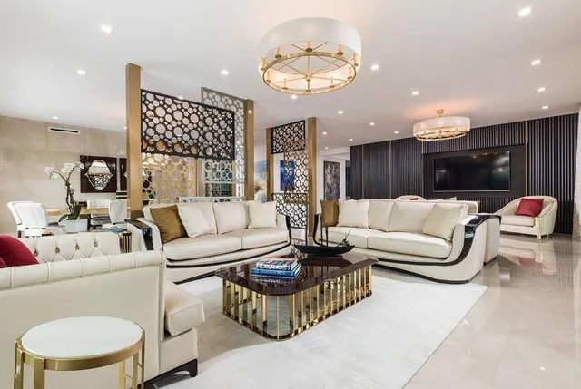 a living room with furniture and large windows