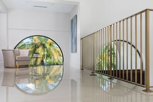 a living room with furniture and a ceiling fan