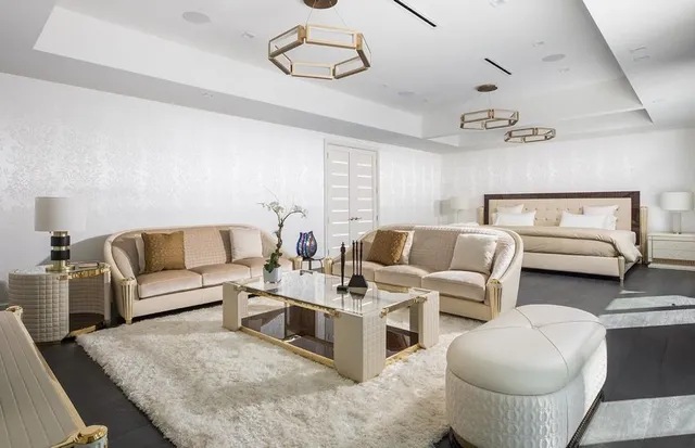 a bedroom with a bed and large window