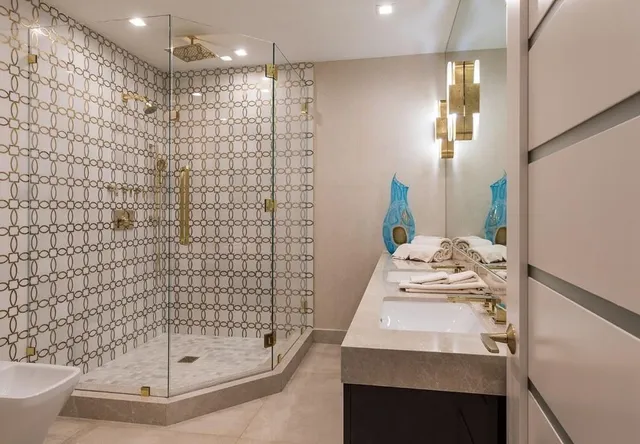 a bathroom with a granite countertop sink mirror and a shower