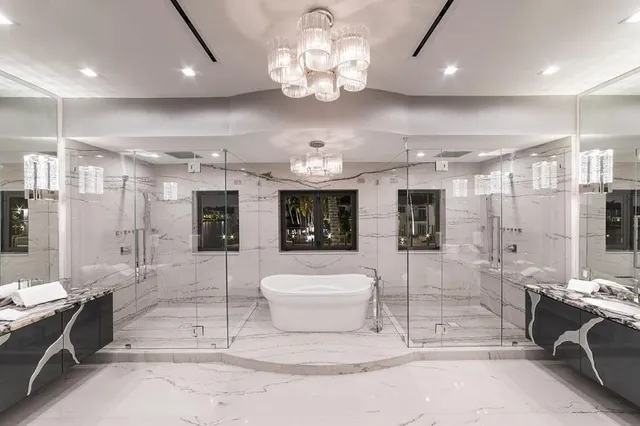 a bathroom with a granite countertop sink a toilet and shower