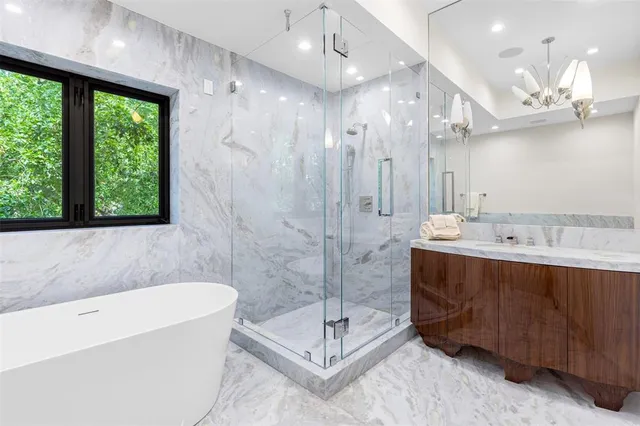 a bedroom with a large bed and a large window