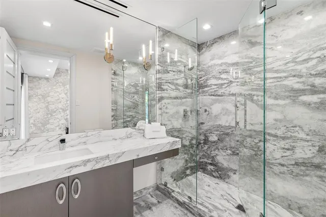 a bathroom with a sink a mirror and a shower