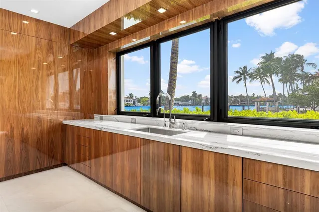 a living room with furniture kitchen and a chandelier