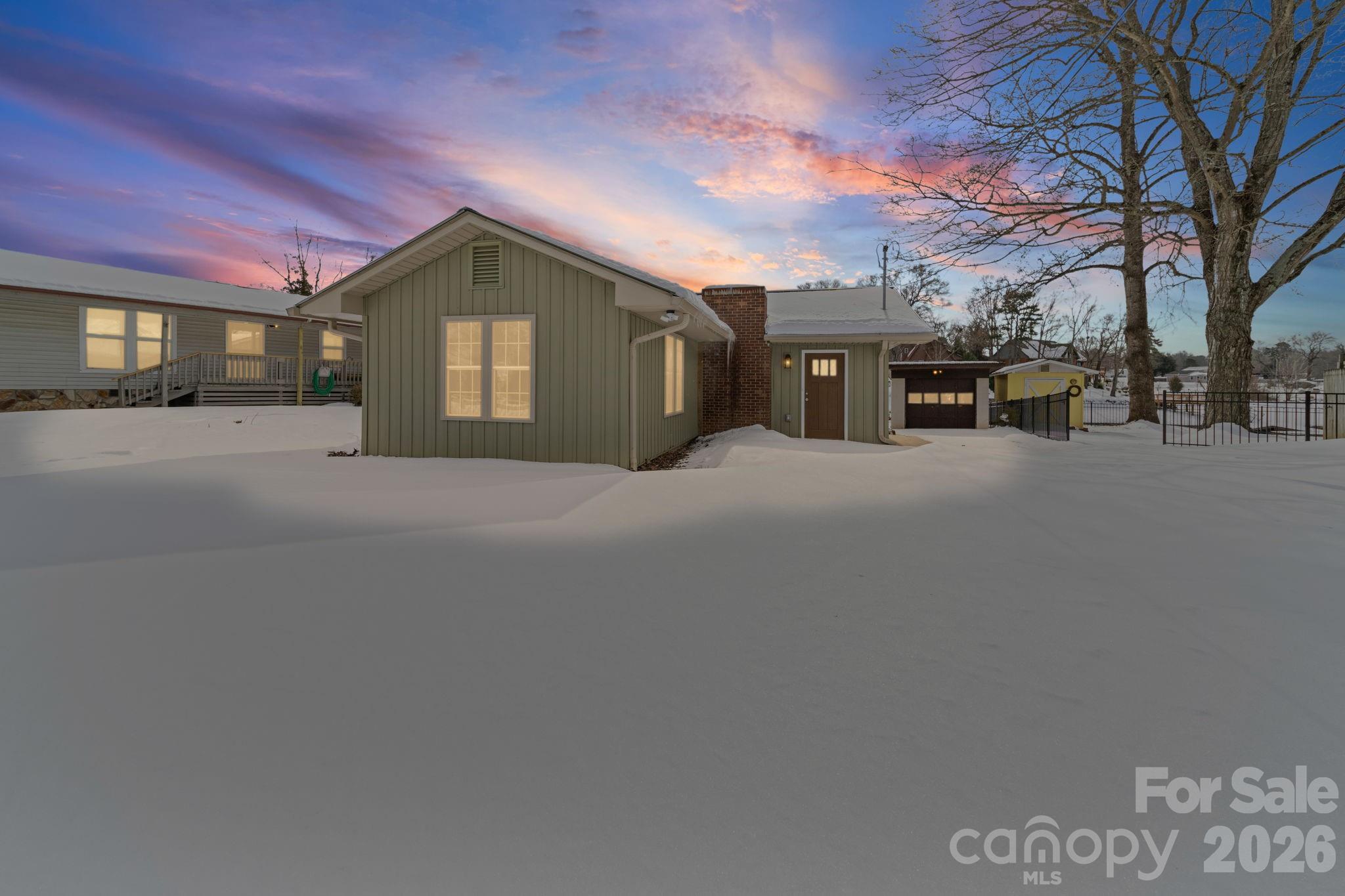 a view of a house with a snow in a yard