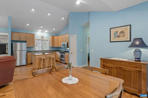 a dining room with furniture and wooden floor