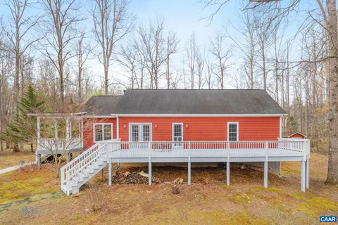 a view of a house with a wooden fence