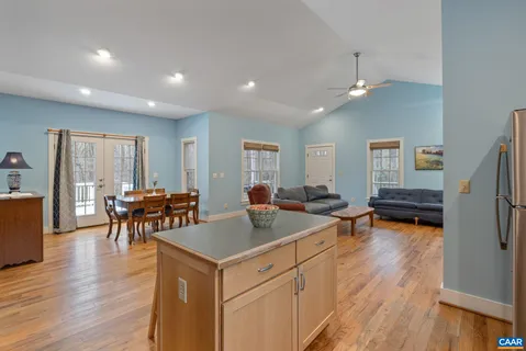 a kitchen with stainless steel appliances granite countertop a refrigerator a stove top oven a sink and dishwasher