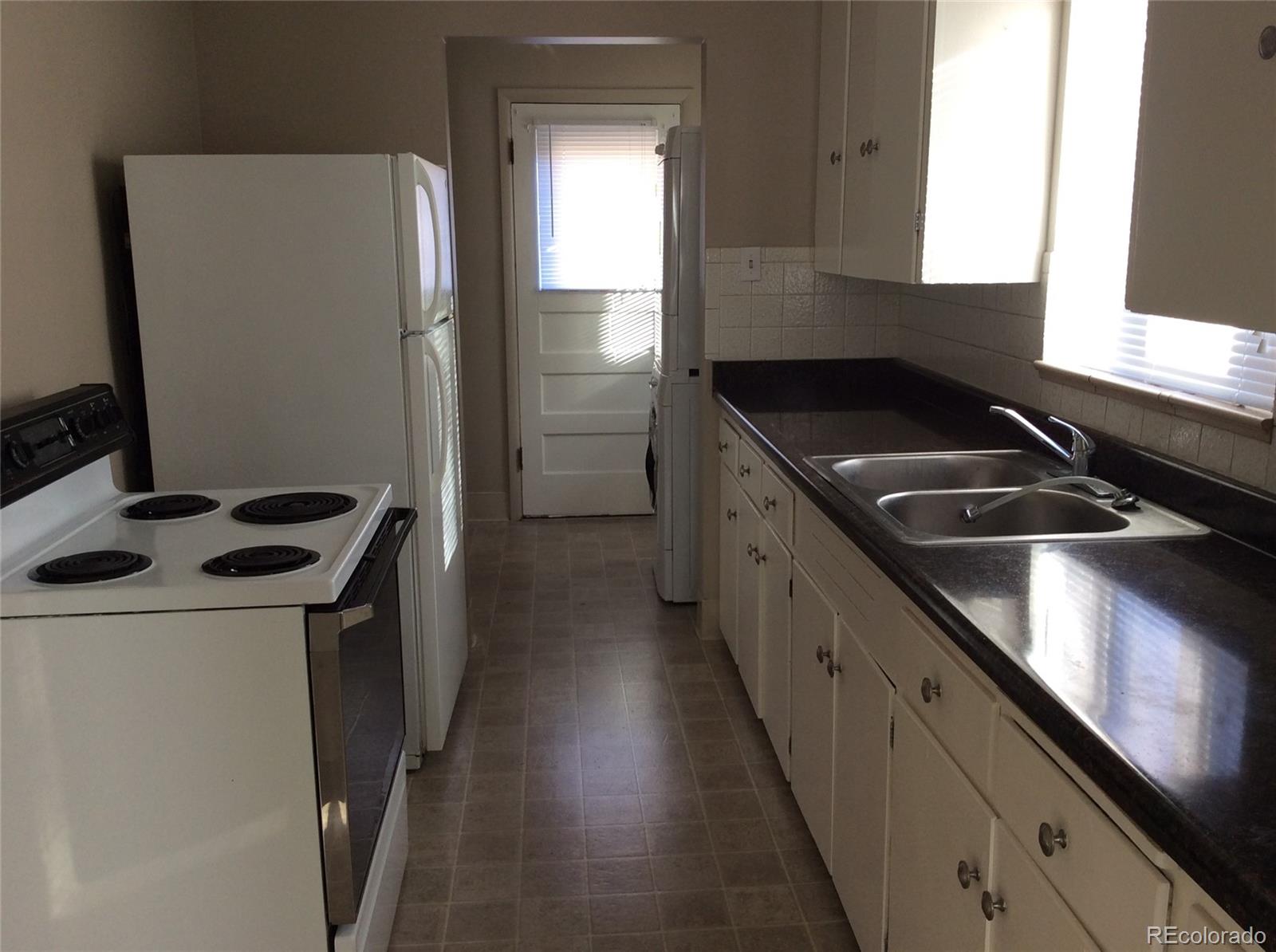 380 South Decatur Street Denver, CO 80219 - Photo 3 of 12 a kitchen that has a sink and a stove