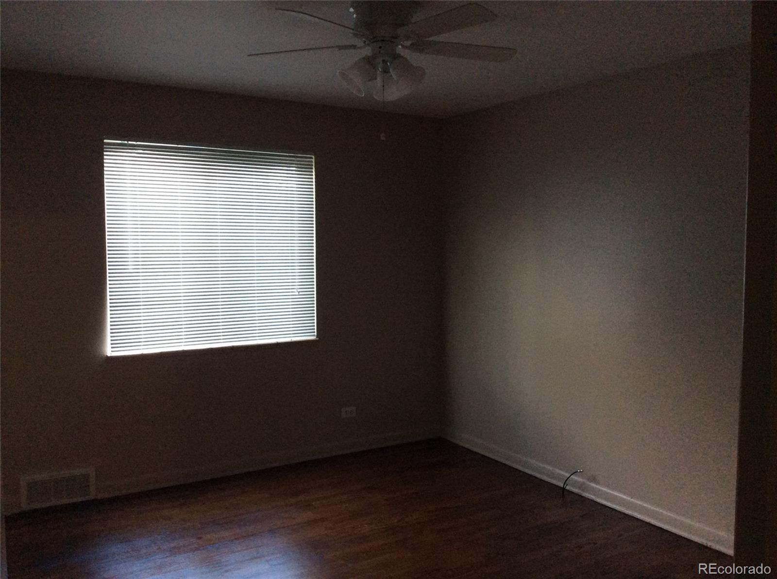 380 South Decatur Street Denver, CO 80219 - Photo 10 of 12 an empty room with wooden floor and windows
